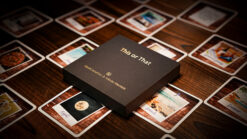 This or That card game box with playing cards spread out on a wooden surface.