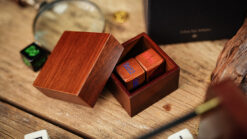 Close-up of numerology dice in a wooden box for magic tricks and mentalism.