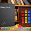 Prophecy Matrix magic trick with colorful number tiles and box setup.