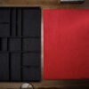 Magicians organizer with red pad for magic tricks and accessories storage.