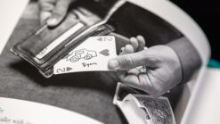 Close-up of a card trick with a wallet and playing cards for magic performances.
