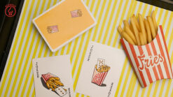 Fries-themed scented playing cards and popcorn box for magic tricks and illusions.
