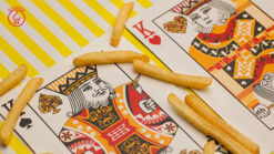 Scented Fries Playing Cards by MPC featuring vibrant king and queen designs on a colorful background.