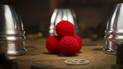 Aluminum alloy cups and red crochet balls for magic tricks and illusions.