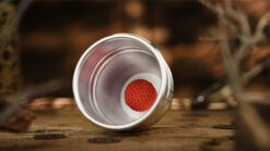 Aluminum alloy cup with red crochet ball for magic tricks and illusions.