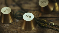 Gold weights with 50g label for magic trick performance.