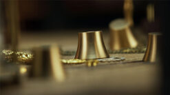 Close-up of gold cups used in the Weights Game magic trick by TCC Magic.