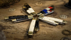 Chroma color-changing knives set displayed on wooden surface for magic tricks.