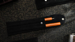 Folding Wand magic trick with wooden handle and case for easy storage and performance.