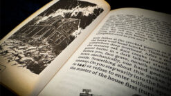 Open book with spooky house illustration for Page Fright by Strange Stage Studios.