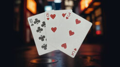 Biker cats playing cards featuring a 10 of clubs, 6 of hearts, 3 of hearts, and 5 of hearts on a dar.