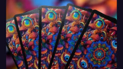 Colorful psychedelic bicycle playing cards with intricate mushroom and eye designs.