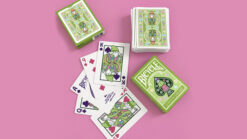 Bicycle Garden Gnome playing cards with colorful gnome design and card deck on pink background.