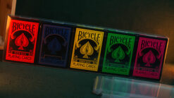 Set of five Bicycle playing card decks with transparent protectors for magic tricks.