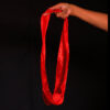 Hand holding a red silk circle for magic illusions, King Solomon's Circle trick.