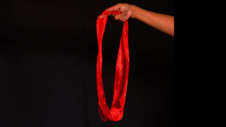 Hand holding a red silk circle for magic illusions, King Solomon's Circle trick.