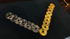 Ancient Chinese coins arranged in a line for a magic trick demonstration.