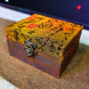 Vintage Chinese coin box with mystical symbols and lock for magic tricks.