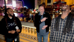 Three magicians performing Spectra by Luke Dancy at a nighttime outdoor event.