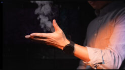 Person performing a magic trick with smoke and Amor Watch on wrist.
