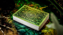 Close-up of a deck of playing cards with an ornate keyhole pattern on the back.