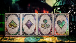 Artistic keyhole reflections with playing cards on a wall, showcasing magic and illusion.