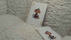 Johnny the Monkey performing a card trick with a deck of playing cards.
