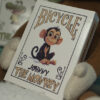 Johnny the Monkey from Bicycle playing cards performing a magic trick.