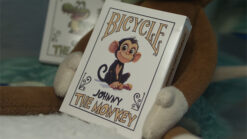 Johnny the Monkey from Bicycle playing cards performing a magic trick.