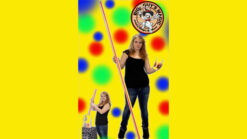 Woman performing the Magical Straw illusion with colorful background for big guys magic show.