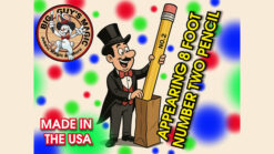 Magician with large two-foot pencil performing magic trick for audience.