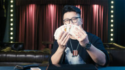 Magician performing the right bill trick with EUR banknotes on stage.