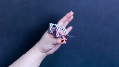 Hand performing Zig Zag Penetration magic trick with playing cards.