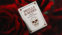 Elegant skull and roses themed playing cards with gilded edges, perfect for magic tricks and card en.