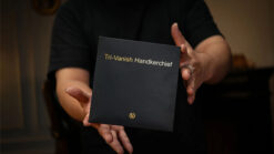 Close-up of magician holding Tri-Vanish Handkerchief box for magic tricks.
