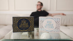 Close-up of Ring Watch Wonder boxes with a magician in the background.